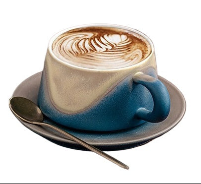 Blue ceramic cup with cappuccino on a white background